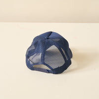 The Darling Effect Navy Game Day Trucker Hat features a mesh adjustable back, shown here from the rear.