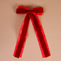 Red Velvet Luxe Layered Hair Bow featuring a red velvet layered bow with two long hanging ribbons attached to a gold barrette clip.