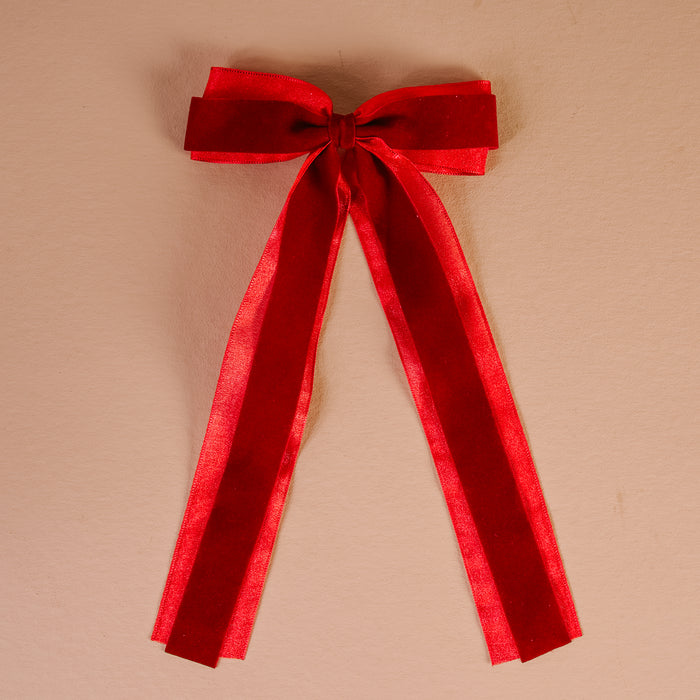 Red Velvet Luxe Layered Hair Bow featuring a red velvet layered bow with two long hanging ribbons attached to a gold barrette clip.