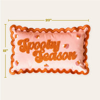 Add festive flair to your sofa with The Darling Effect's Spooky Season Scalloped Rectangle Throw Pillow—20" x 12", peach with orange scalloped edges, “Spooky Season” in textured orange letters, plus candy corn accents.