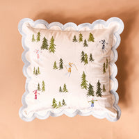 The Darling Effect's Aprés Ski Scalloped Square Throw Pillow features scalloped white edges and embroidered skiers and green trees, adding cozy lodge charm to your mountain retreat or après-ski décor.