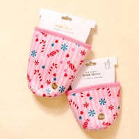 Two pink Sugar Rush Sip Savvy Drink Sleeves by The Darling Effect, featuring red and white candy cane and peppermint designs, are displayed on a light beige background. Each festive sleeve includes a “Sip Savvy drink sleeve” tag.