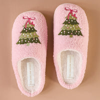 Pair of pink fuzzy slippers with embroidered Christmas tree tops and cushioned soles