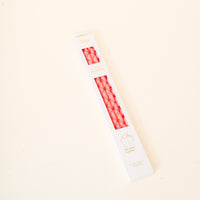 A rectangular white box of The Darling Effect Festive Plaid 40 oz Tumbler Straw Set with a diamond pattern is displayed on an off-white surface. The packaging features gold and red text highlighting the reusable straws.