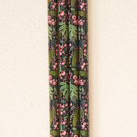 Five pencils with a dark background and pink berries, green leaves, and small flowers are arranged side by side—perfect for pairing with The Darling Effect’s Jolly Sprig Green 40 oz Tumbler Straw Set.
