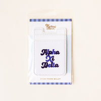 The Alpha Xi Delta Stick-On Phone Wallet by The Darling Effect features navy blue cursive lettering, a blue and white striped border, and comes in packaging—making it an ideal sorority gift.