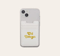 The Darling Effect Chi Omega Stick-On Phone Wallet is a clear phone case accessory featuring a white card holder attached to the back. With “Chi Omega” elegantly scripted in gold, this convenient phone wallet makes the perfect thoughtful gift for any sorority member.