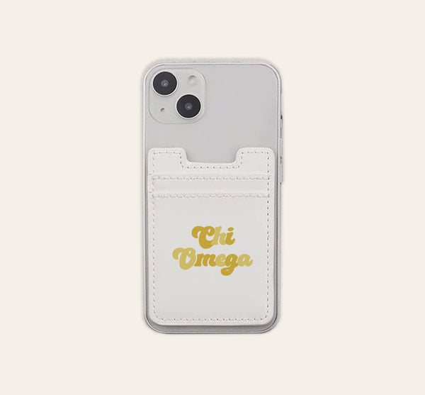 The Darling Effect Chi Omega Stick-On Phone Wallet is a clear phone case accessory featuring a white card holder attached to the back. With “Chi Omega” elegantly scripted in gold, this convenient phone wallet makes the perfect thoughtful gift for any sorority member.