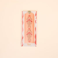The Everbloom Dusty Rose Acrylic Bookmark by The Darling Effect features a floral design, green velvet ribbon tassel, and comes packaged in plastic—a charming gift for book lovers.