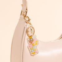 The-darling-effect's Best Teacher Ever Acrylic Keychain is a pocket-sized cream accessory, featuring pastel block letters and a translucent bear charm—making it a super cute gift for teachers.