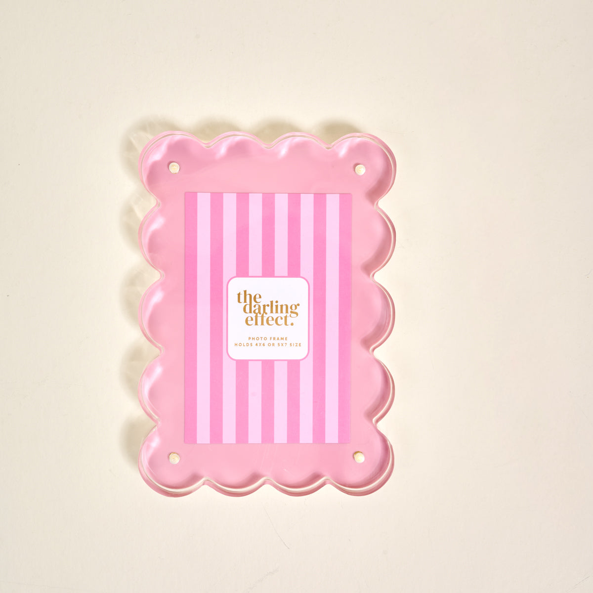 The Darling Effect's Blush Rectangle Scalloped Acrylic Picture Frame showcases a pink-striped insert and cream background, fitting 4x6 or 5x7 photos—an elegant modern piece for your picture frame collection.
