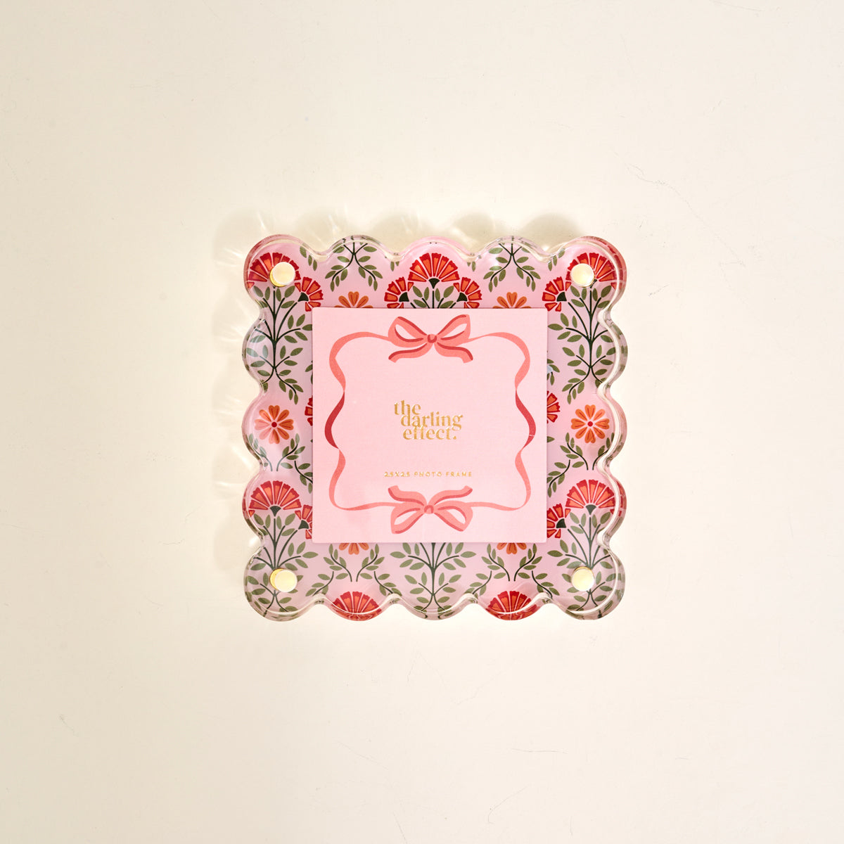 The Everbloom Dusty Rose Little Moments Acrylic Picture Frame by The Darling Effect features a square notepad with scalloped edges, pink floral border, corner holes, and gold "the sterling effect" text on cream, set in an elegant acrylic frame.