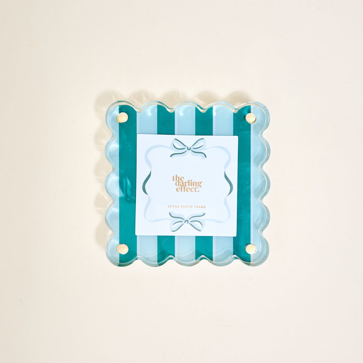 The Darling Effect's Sicily Stripes Teal Little Moments Acrylic Picture Frame features scalloped edges, alternating teal and light blue stripes, a centered card with gold text and bow illustration, plus gold studs in each corner for elegance.
