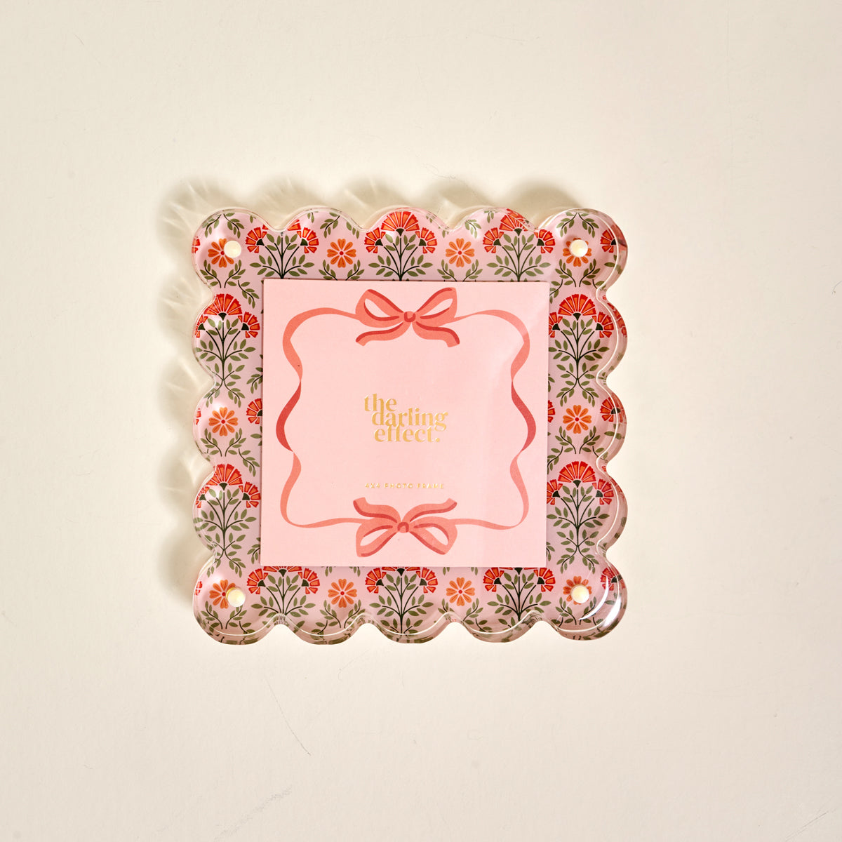 The Everbloom Dusty Rose Square Scalloped Acrylic Picture Frame by The Darling Effect features a decorative tray-like design with floral patterns, pink accents, and modern charm—perfect for displaying treasured memories.