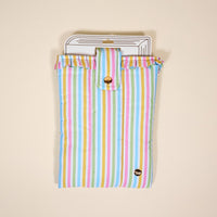 The Darling Effect’s Color Me Happy Book Cover features pastel stripes, ruffled edges, and a gold snap closure—a cute puffy polyester pouch that protects your books in style.