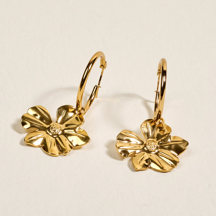 The Darling Effect’s Sunlit Petal Standout Earrings feature dangling flower charms and a high-shine finish—ideal for adding elegant flair to your special occasion jewelry collection.