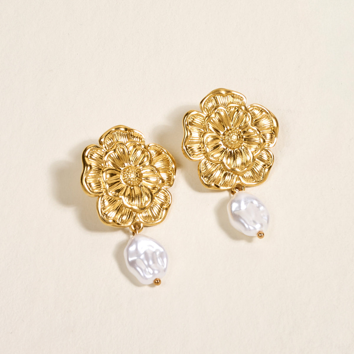 Make a statement at any special occasion with The Darling Effect’s Vintage Bloom Standout Earrings—elegant golden earrings featuring gold flower details and baroque pearl drops.