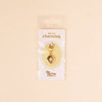 The Compass Jewelry Charm Gold by the-darling-effect comes on a white card labeled 'OH SO charming' and is packaged in a clear bag—an ideal addition to your charm bar collection.