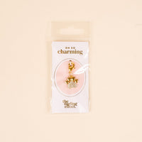 The Darling Effect's Dazzled Paw Print Jewelry Charm Gold features a rhinestone-studded paw design on an OH SO charming card, packaged in a clear sleeve—perfect for adding sparkle to any charm bar collection.
