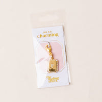 The-darling-effect’s F Jewelry Charm Initial Letter Gold features a gold-plated, rhinestone-studded F charm on an Oh So Charming card in a clear sleeve—ideal for personalized jewelry, displayed against a light beige background.