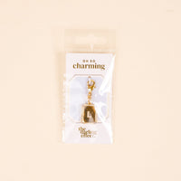 The-darling-effect L Jewelry Charm Initial Letter Gold features a gold-plated brass charm with a diamond-encrusted border and clasp, packaged in plastic with "OH SO charming" and "the darling effect."—perfect for personalized jewelry lovers.