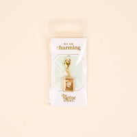 The P Jewelry Charm Initial Letter Gold by the-darling-effect is a gold-plated brass lock-shaped charm on a white card with gold "OH SO charming" and "the darling effect" text, packaged in a clear bag—ideal for personalized jewelry.