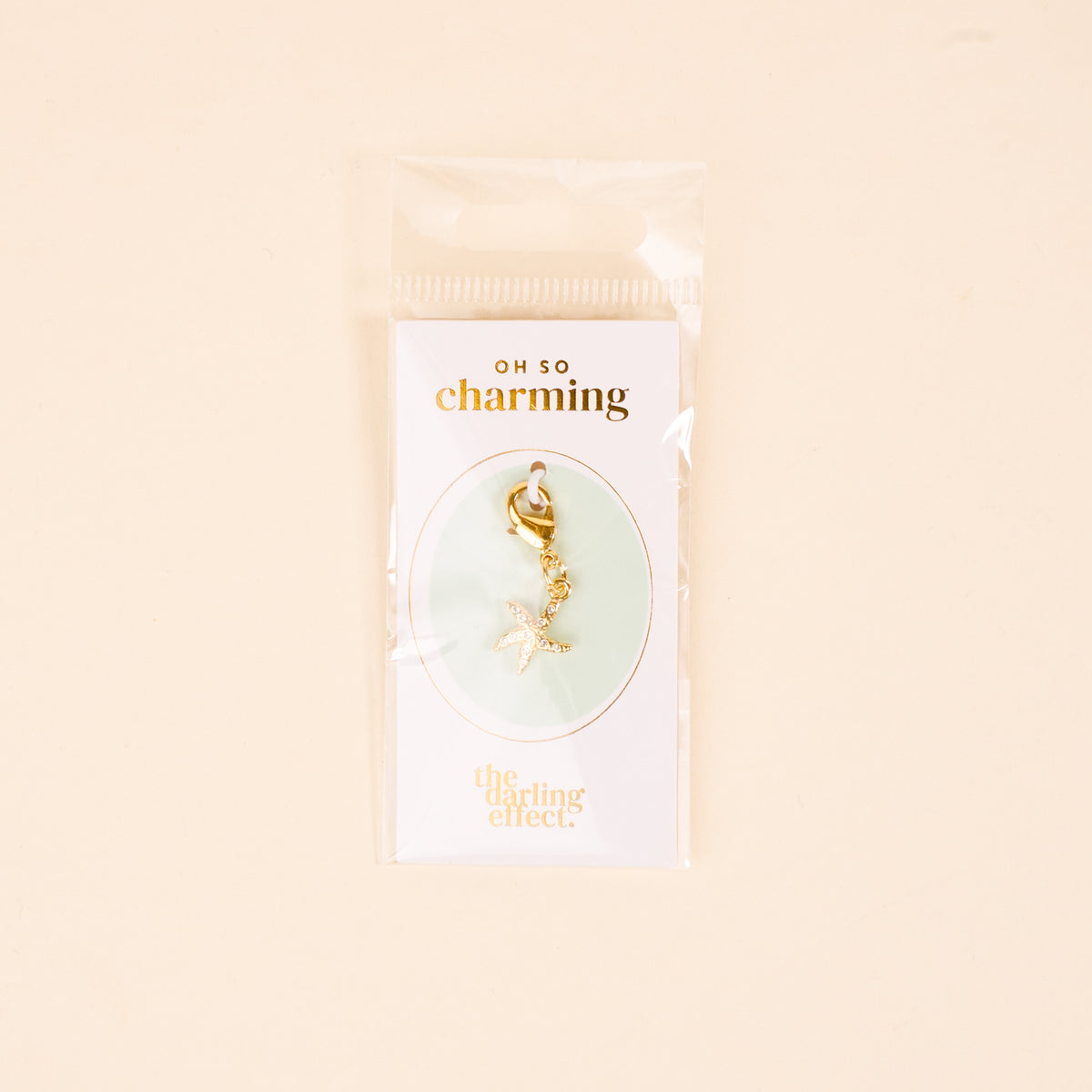 The Darling Effect’s Starfish Jewelry Charm Gold features sparkling rhinestones and a clasp, perfect for adding to your jewelry charm collection or charm bar.