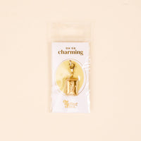 Add unique flair to your charm jewelry with the Tulip Time Jewelry Charm Gold by The Darling Effect—a gold-tone tulip in a rectangular frame on a lobster clasp. Comes in plastic packaging with “OH SO charming” and The Darling Effect branding.