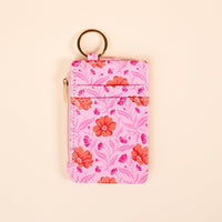 The Darling Effect's Poppin' Petals Hot Pink Keychain Wallet features a floral design and gold keychain, keeping your essentials stylishly organized in a slim profile.