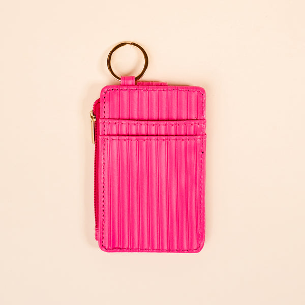 The Darling Effect's Hot Pink Ripple Ridge Keychain Wallet features two card slots, a zippered coin holder, and a gold keyring, shown against a light beige background.