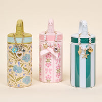 The Darling Effect's Book Shelfie 6 oz Lil' Bitty Bottle features floral designs, pink and green stripes—perfect as a stylish travel companion.