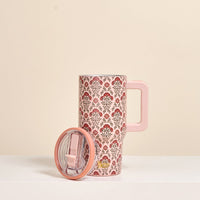 The Darling Effect Everbloom Dusty Rose 20 oz Lifestyle Flip Straw Tumbler, featuring a red and gray floral design, stands upright with its matching lid on a white surface against a beige background.