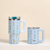 Two light blue mugs with matching vertical floral and bow designs and white handles sit side by side. One is the-darling-effect's Oh So Fancy Blue 20 oz Lifestyle Flip Straw Tumbler, featuring a clear lid for insulated sipping.