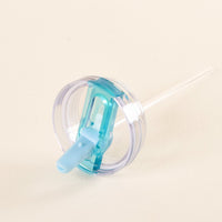 The-darling-effect Blue 40 oz Lifestyle Flip Straw Lid features a clear plastic flip-top cover with a built-in blue silicone straw. Shown on a light beige background, its leak-resistant design is perfect for spill-free hydration on the go.