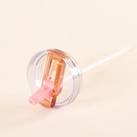The Pink 40 oz Lifestyle Flip Straw Lid tumbler by the-darling-effect features a pink spout, rose gold flip-top closure, leak-resistant design, and a clear straw for easy hydration—all on a stylish cream background.