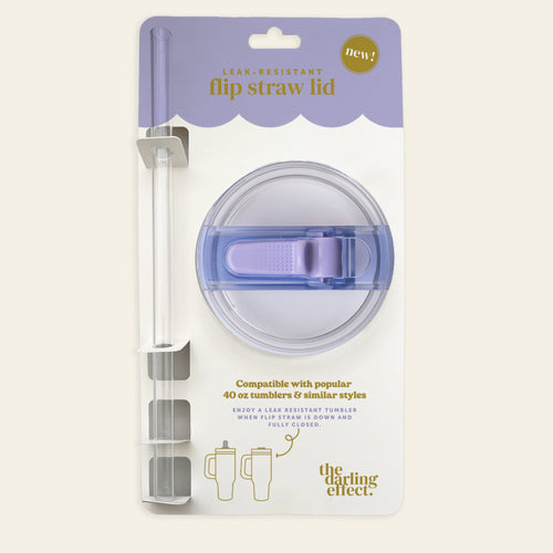 The Periwinkle 40 oz Lifestyle Flip Straw Lid by the-darling-effect features a round, clear lid with a purple flip top and straw. Leak-resistant and perfect for hydration on the go, it fits 40 oz tumblers and comes in branded packaging.