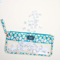 The Darling Effect’s It's Mahj Time Teal Mahjong Tile Keeper Pouch features a clear window revealing tiles inside and out, blending teal and pink style for chic tile storage.