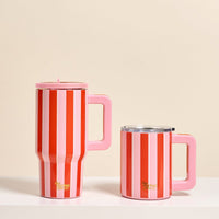 Two Sicily Stripes Pink 14 oz Insulated Mugs by The Darling Effect sit side by side on a white surface. Both feature vertical red and pink stripes with gold text, large handles, and clear lids; one mug is taller than the other.