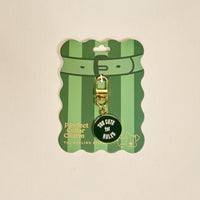 The Darling Effect's Too Cute for Rules Pawfect Collar Charm is displayed on a green and white striped card, featuring a gold charm—perfect for pet style lovers and trendy collar charm fans.