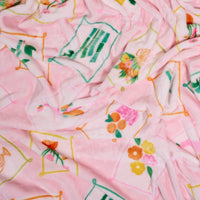 The Darling Effect’s It’s Mahj Time Snuggle Up Plush Blanket features a pink, fluffy texture and vintage framed flower-and-fruit design for soft comfort and timeless style.