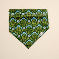 The Darling Effect Bow-Wow Pet Bandana-Everbloom Forest Green features a green base with blue and white flowers and green leaves—perfect as a stylish pet accessory or dog bandana.
