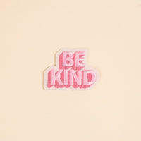 The Darling Effect's Be Kind Mix & Match Iron-On Patch features bold pink and white embroidery with "BE KIND" in uppercase—ideal for adding a positive touch to any item.