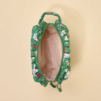 The Darling Effect Dog Days Essentials Quilted Cosmetic Pouch is a small green bag featuring a dog print, gold zipper, short handle, and beige and white striped lining, shown from above with the zipper open.