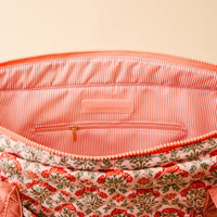 The Everbloom Dusty Rose The Everyday Quilted Tote Bag by The Darling Effect features an open floral quilted design, pink and white striped lining, inner zip pocket, and a branded label—perfect for daily use.