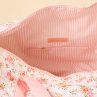 Interior view of the Endless Daydream Cream On-the-Go Quilted Weekender Bag by the-darling-effect, open to show a pink and white striped lining, interior zip pocket with gold zip pull, and brand label—a stylish choice for your next trip.