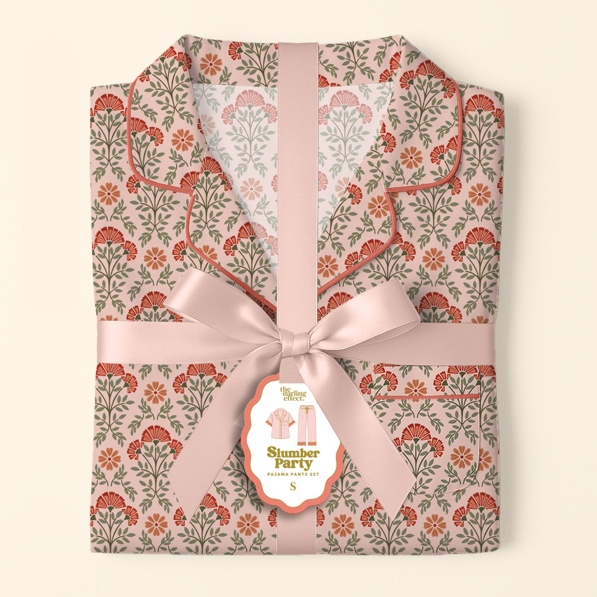 The Darling Effect's Everbloom Dusty Rose Slumber Party Pajama Pants Set features ultra-soft, floral-patterned fabric, neatly folded and tied with a pale pink ribbon—gift-ready for any occasion.