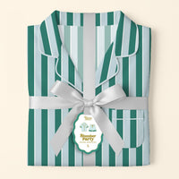 The Darling Effect’s Sicily Stripes Teal Slumber Party Pajama Shorts Set, in ultra-soft fabric with teal and light blue stripes, is folded and tied with a silver ribbon, featuring a gift tag showing a small pajamas illustration and "S" for size.