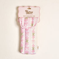 The Darling Effect's Oh So Fancy Pink Puffy Sunglasses Case features a pink and white quilted design with bow and flower accents, a magnetic flap closure, side tag, and comes in packaging labeled "PUFFY SUNGLASSES CASE.