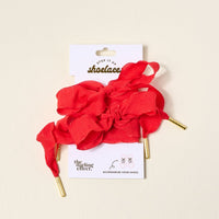 Add a pop of color with The Darling Effect's Frilly Red Step It Up Shoelaces—durable red laces with gold tips, displayed on a branded card. Perfect for tying in loose bows to give your sneakers a stylish upgrade.