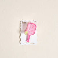The Darling Effect Pickleball Paddle Shape Up Claw Clip is a pink paddle-shaped hair accessory with a small green pickleball, presented on a white scalloped card printed with "the darling effect" and "1 shape claw clip.